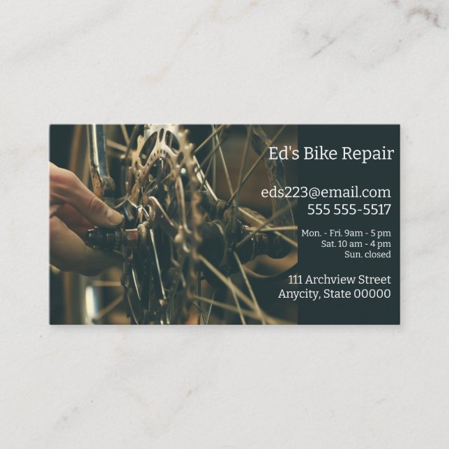 Man makes adjustments on bike wheel business card (Front)