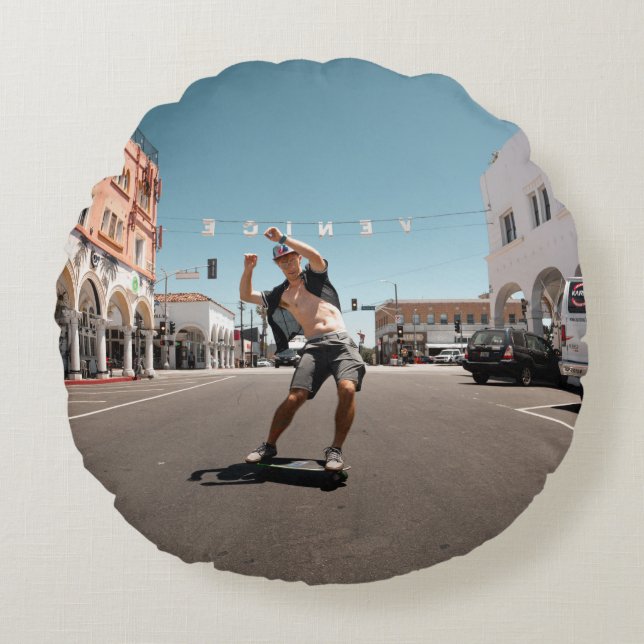 Man playing skateboard round pillow (Front)