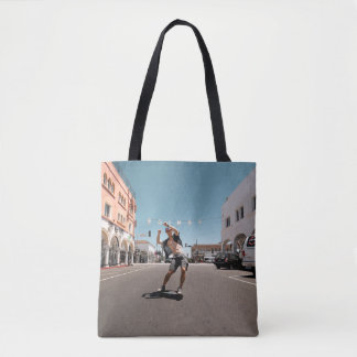 Man playing skateboard tote bag