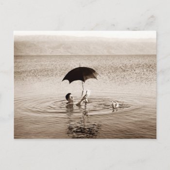 Man Reading Under Umbrella In The Dead Sea Postcard by HTMimages at Zazzle