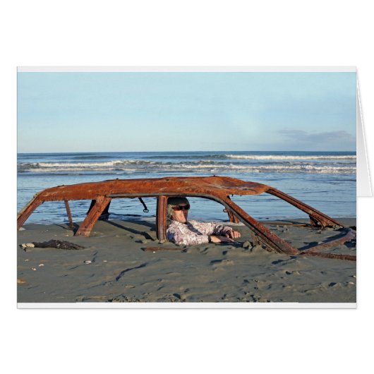 Man sitting in rusty car on beach (Front Horizontal)