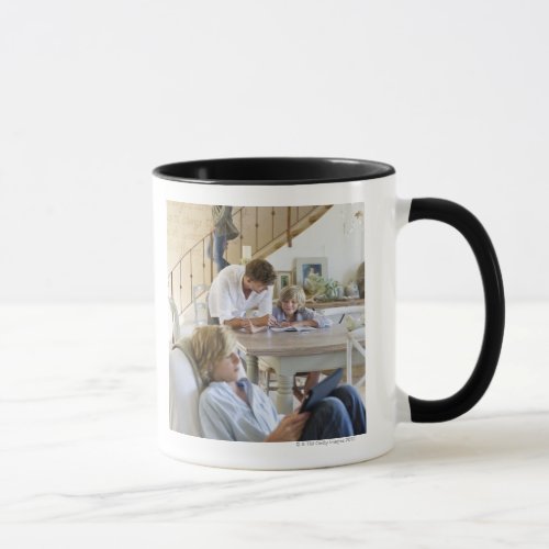 Man talking to little boy with brother using mug
