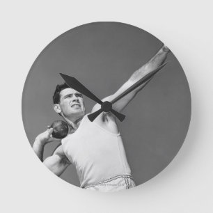 Man Throwing Shotput Round Clock