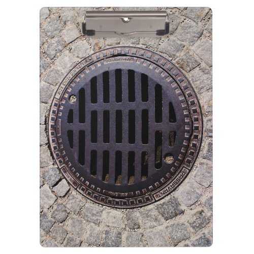 Manhole cover and cobblestone road clipboard