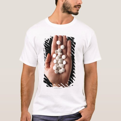 Many white pills in the palm of a person T_Shirt
