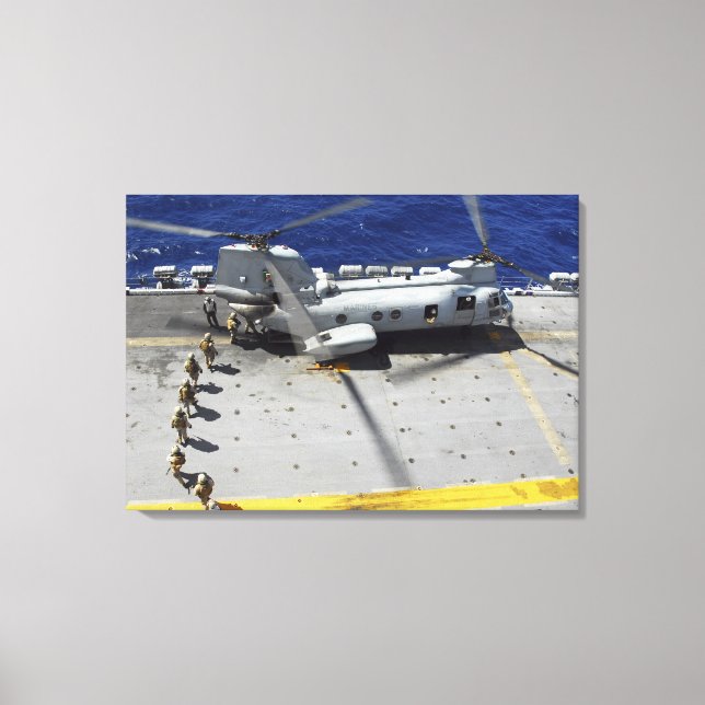 Marines board a CH-46E Sea Knight helicopter Canvas Print (Front)