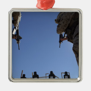 Marines change magazines in the midst of firing metal ornament