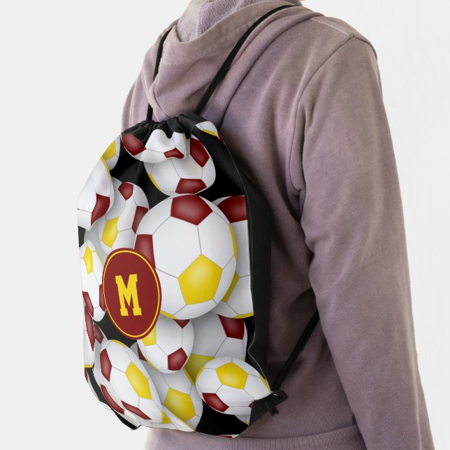 maroon gold team colors soccer balls pattern drawstring bag (Insitu)