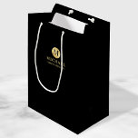 Masculine Black and Gold Personalized Groomsmen Medium Gift Bag<br><div class="desc">Add a personal touch to your wedding with personalized groomsmen gift bag. This gift bag features black monogram in gold circle element with name and title in gold professional font style on black background. Also perfect for best man, father of the bride, ring bearer and more. Please Note : The...</div>