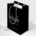 Masculine Black Personalized Groomsmen Medium Gift Bag<br><div class="desc">Add a personal touch to your wedding with personalized groomsmen gift bag. This gift bag features personalized groomsman's name with title and wedding date in white and monogram in grey as background, in classic serif font style, on black background. Also perfect for best man, father of the bride, ring bearer...</div>