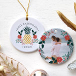 Mele Kalikimaka | Hawaiian Christmas Photo Ceramic Ornament<br><div class="desc">Festive holiday ornament features a Christmas pineapple illustration flanked by red poinsettia flowers and green holly,  with the Hawaiian Christmas greeting "Mele Kalikimaka" curved above. Personalize with the year for a tropical chic holiday keepsake,  and add a favorite photo to the reverse side,  surrounded by matching lorals and branches.</div>