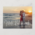Mele Kalikimaka Modern Beach Photo Christmas Holiday Postcard<br><div class="desc">Send out holiday cheer with this modern Christmas postcard featuring a simple design with the Hawaiian greeting "Mele Kalikimaka" in an elegant thin white script,  along with your names and year over your favorite photo.  The backside has your personal message and your return address for easy mailing.</div>