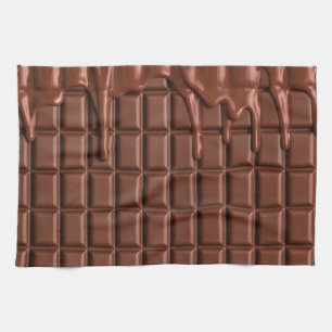 Melted chocolate dripping over a chocolate block kitchen towel