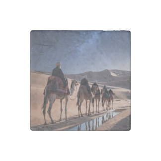 men riding camels across a desert night stone magnet