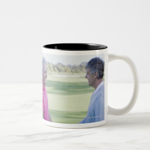 Men shaking hands on golf course Two_Tone coffee mug