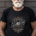 Mens Funny Whiskey 80th Birthday T-Shirt<br><div class="desc">Celebrate the big 8-0 with style and humor with this vintage whiskey label-inspired birthday design. The black, gold, and white typography is ornate and elegant, giving it a classic retro vintage feel. Perfect for man (or woman!) in your life who loves their scotch, spirits, bourbon, and other liquor drinks. Features...</div>