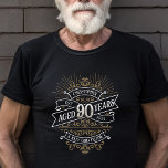 Mens Funny Whiskey 90th Birthday T-Shirt<br><div class="desc">Celebrate the big 9-0 with style and humor with this vintage whiskey label-inspired birthday design. The black, gold, and white typography is ornate and elegant, giving it a classic retro vintage feel. Perfect for man (or woman!) in your life who loves their scotch, spirits, bourbon, and other liquor drinks. Features...</div>