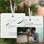 Merry and Engaged Photo and Elegant Calligraphy Ceramic Ornament<br><div class="desc">Merry & Engaged Christmas photo ornament which you can personalize with your favorite photo and persoanlized wording. Elegant typographic design with swirly calligraphy and easy to edit for an engaged couple. This holiday ornament is lettered with Merry & Engaged on one side and editable text on the other. The sample...</div>