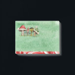 Merry ChrisMUSH Cartoon Mushrooms Post-it Notes<br><div class="desc">Use these cute cartoon mushroom caps (wearing caps) for fun holiday notes.  Text (that can be customized) reads: Merry ChrisMUSH! These have a textured watercolor pattern in green on the paper and a candy cane narrow border on the bottom in red and white.  Spread the cheer!  Happy Holidays!</div>
