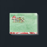 Merry ChrisMUSH Cartoon Mushrooms Post-it Notes<br><div class="desc">Use these cute cartoon mushroom caps (wearing caps) for fun holiday notes.  Text (that can be customized) reads: Merry ChrisMUSH! These have a textured watercolor pattern in green on the paper and a candy cane narrow border on the bottom in red and white.  Spread the cheer!  Happy Holidays!</div>