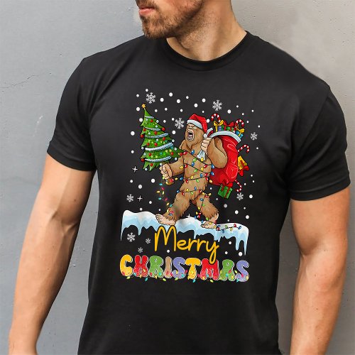 Merry Christmas Bigfoot Carrying Christmas Tree T_Shirt