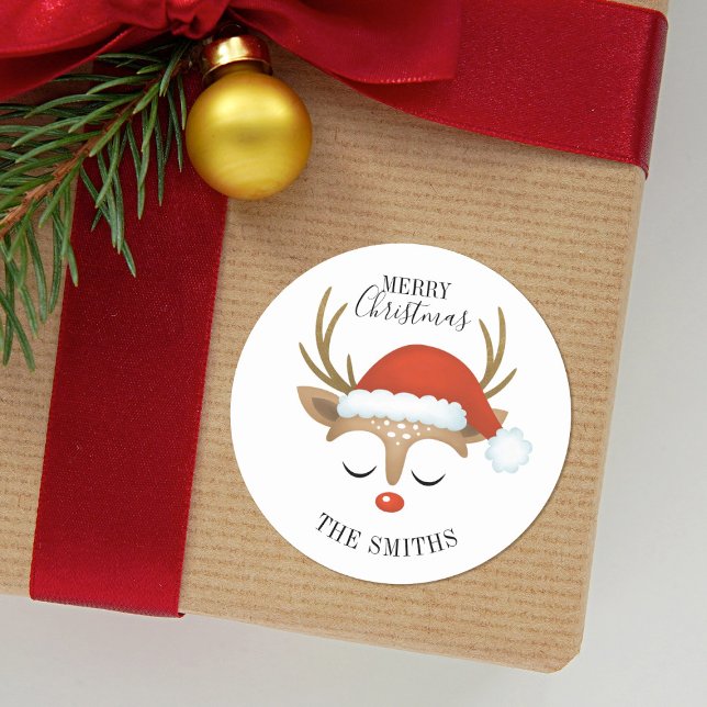 Merry Christmas Cute Reindeer Classic Round Sticke Sticker (A cute Reindeer with a Santa hat decorates this Christmas Sticker. Fun for your kids presents.)