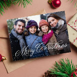 Merry Christmas elegant script one photo snow Holiday Card<br><div class="desc">"Merry Christmas" in an elegant script sits atop of a single horizontal photo framed with a snowy speckle. This classic card is the perfect way to send Christmas greetings to friends and family. The back is a festive red speckled with a coordinating snowy pattern. The red color can be changed...</div>