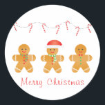 Merry Christmas Gingerbread Men Classic Round Sticker<br><div class="desc">Cute illustration of three gingerbread men dressed in holiday attire. Santa hat,  winter scarves,  and cute colorful buttons bring holiday cheer to this design. Gingerbread men are an essential to the Christmas season and this design is perfect to bring cheer this season!</div>