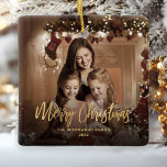 Merry Christmas Gold Script Family Photo Ceramic Ornament<br><div class="desc">Spread holiday cheer to friends and family with this modern keepsake ornament. The gold faux foil text reads "Merry Christmas" in elegant handwriting script. Replace the sample image with your favorite photo,  and add your family name and the year. A black gradient filter helps make the text pop.</div>