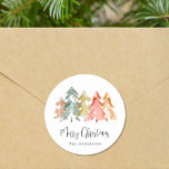 Merry Christmas Pine Tree Watercolor Classic Round Sticker<br><div class="desc">Simple and elegant stickers for your holidays gifts and correspondence featuring a watercolor abstract of pine trees in muted sage green,  red,  gold and orange,  "Merry Christmas" in a stylish script and your name in modern typography.</div>