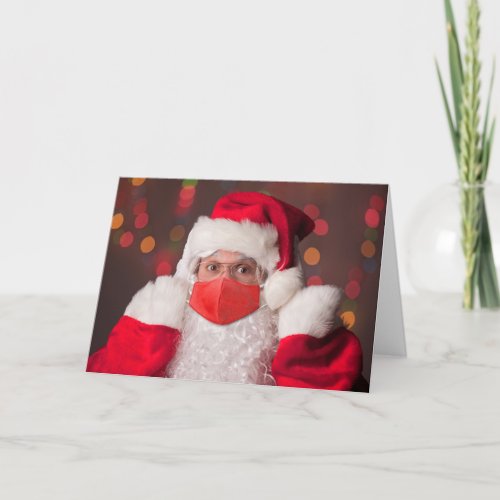 Merry Christmas Santa Claus Putting on Face Mask Holiday Card