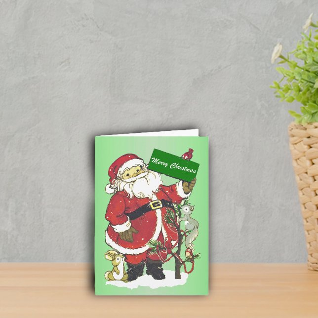 Merry Christmas Santa Forest Animals Tree Snow Holiday Card (cute Santa with little animals around decorated tree in snow on green Merry Christmas greeting card.)