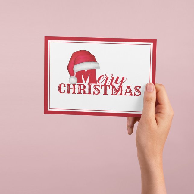Merry Christmas Santa Hat Typography Holiday Card (Merry Christmas holiday card with red Santa hat and festive typography greeting.)
