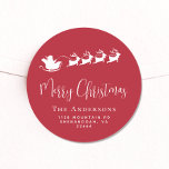Merry Christmas Santa Reindeer Red Return Address Classic Round Sticker<br><div class="desc">Fun seasonal red sticker for your Christmas holiday cards and correspondence featuring a white silhouette of reindeers flying Santa's sleigh through air,  "Merry Christmas" in a stylish white script and your family name and address in simple modern white typography.</div>