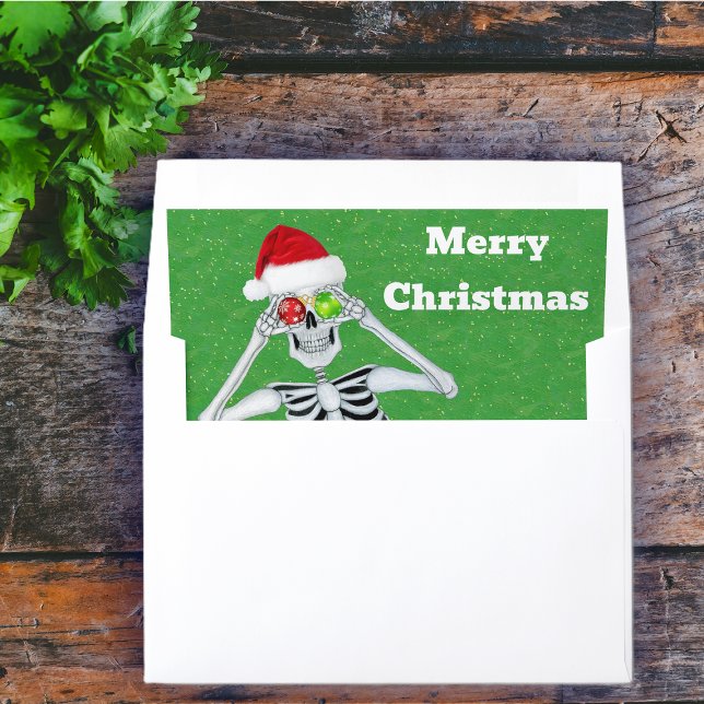 Merry Christmas Skeleton Ornaments Santa Hat Green Envelope Liner (Happy Merry Christmas skeleton ornament eyes on green holiday mailing envelope liner.)