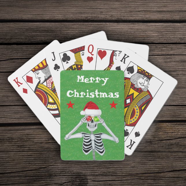 Merry Christmas Skeleton Ornaments Stars Santa Hat Poker Cards (Merry Christmas silly skeleton ornament eyes  red stars on green deck of playing cards.)