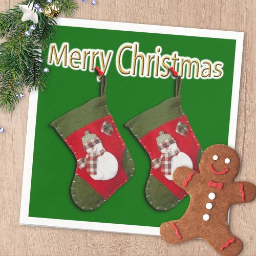Merry Christmas Snowman On Stocking Over Green Paper Napkins