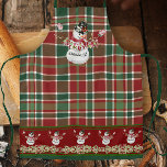 Merry Christmas Snowman Watercolor Plaid w Holly Apron<br><div class="desc">"Merry Christmas Snowman Watercolor Plaid w Holly." Lovely classic, traditional style holiday, Christmas season apron swith an adorable snowman displaying a banner that ays, "Merry Christmas!" A Christmas plaid of red, white and green background and aborder of holly leaf foliage and berries all painted in watercolors by internationally licensed artist...</div>