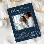 Merry Christmas Winter Village Hand Drawn Foil Holiday Card<br><div class="desc">Share the peaceful charm of a winter's night with this stunning holiday card featuring a cozy village scene. The deep navy blue background beautifully contrasts the delightful illustration of snow-covered houses, trees, and stars, all glowing in brilliant silver foil. Your favorite family photo is elegantly framed in the center, while...</div>