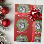 Merry Christmas Wreath Custom Dog Photo Red Wrapping Paper<br><div class="desc">Beautiful custom pet Christmas wrapping paper featuring a green holiday wreath on a red background. Replace with your dog's photo in the center of the wreath or add a personalized cat picture for your friends and family. Merry Christmas is written in white. Customize with your own text underneath.</div>
