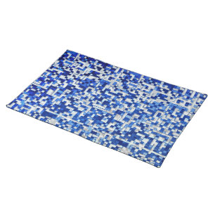 Mess of small squares, shades of blue with white cloth placemat