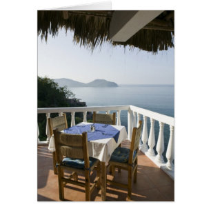 Mexico, Guerrero, Zihuatanejo. Cafe Table over Cards