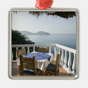 Mexico, Guerrero, Zihuatanejo. Cafe Table over Metal Ornament
