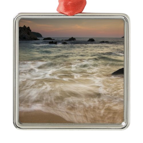 Mexico, Guerrero, Zihuatanejo.  Surf along a Metal Ornament