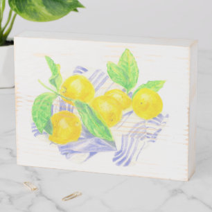 Meyer lemons on kitchen towel wooden box sign