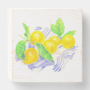 Meyer lemons on kitchen towel wooden box sign