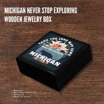 Michigan Never Stop Exploring Wooden Jewelry Box<br><div class="desc">Store your precious keepsakes and jewelry in this beautifully crafted wooden jewelry box featuring a stunning design that celebrates the spirit of Michigan adventure. The lid showcases an artistic depiction of the Porcupine Mountains and a motivational slogan, "Take The Long Way Home - Never Stop Exploring." This unique design captures...</div>