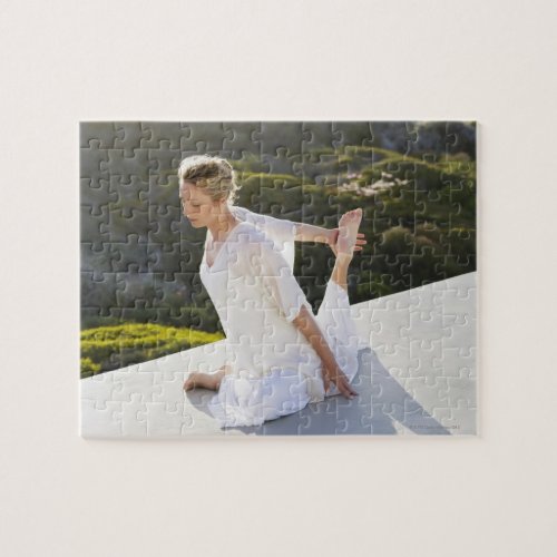 Mid adult woman practicing yoga exercise at jigsaw puzzle