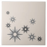 Mid-Century Modern Starburst Silver Ceramic Tile<br><div class="desc">Mid-century modern inspired design featuring vintage retro starbursts in shades of silver gray on a light background. Simple,  clean modern design.</div>