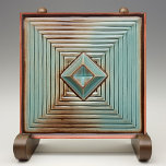 Midcentury Geometric Elegance Earthy Teal Ceramic Tile<br><div class="desc">Elevate your space with the chic sophistication of the "Geometric Elegance Ceramic Print Tile." This tile features a captivating geometric pattern with layers of concentric squares and a central diamond, rendered in soothing tones of teal, accented with earthy browns and set against a warm, cream backdrop. The design mimics the...</div>